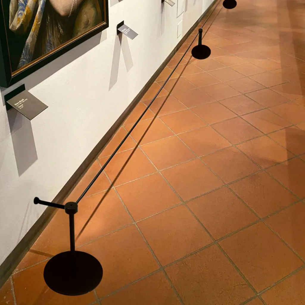 Système de délimitation intérieur avec corde élastique et poteaux noirs en espace d'exposition – TELNALINE